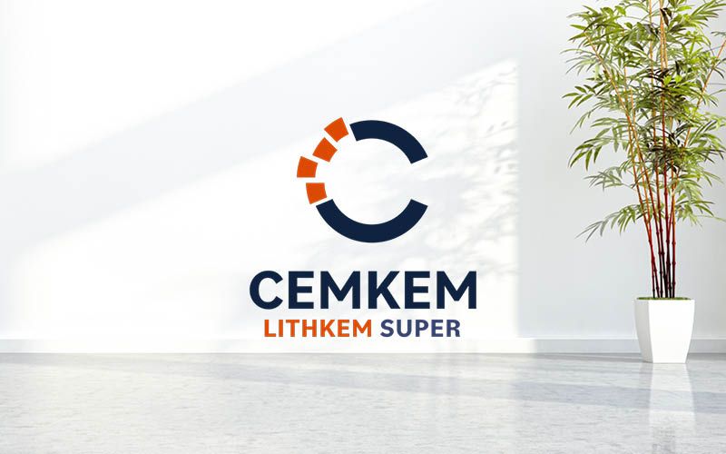 A logo with text "CEMKEM LITHKEM SUPER" on a white wall, illuminated by natural light, next to a potted plant, in a clean, bright room.