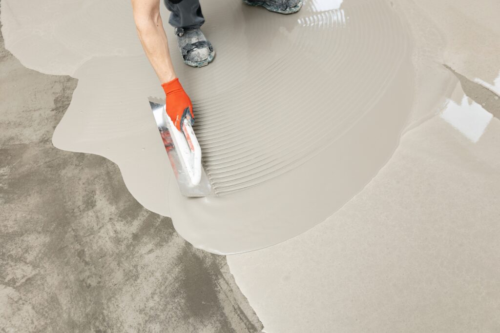 construction worker smoothing out screed